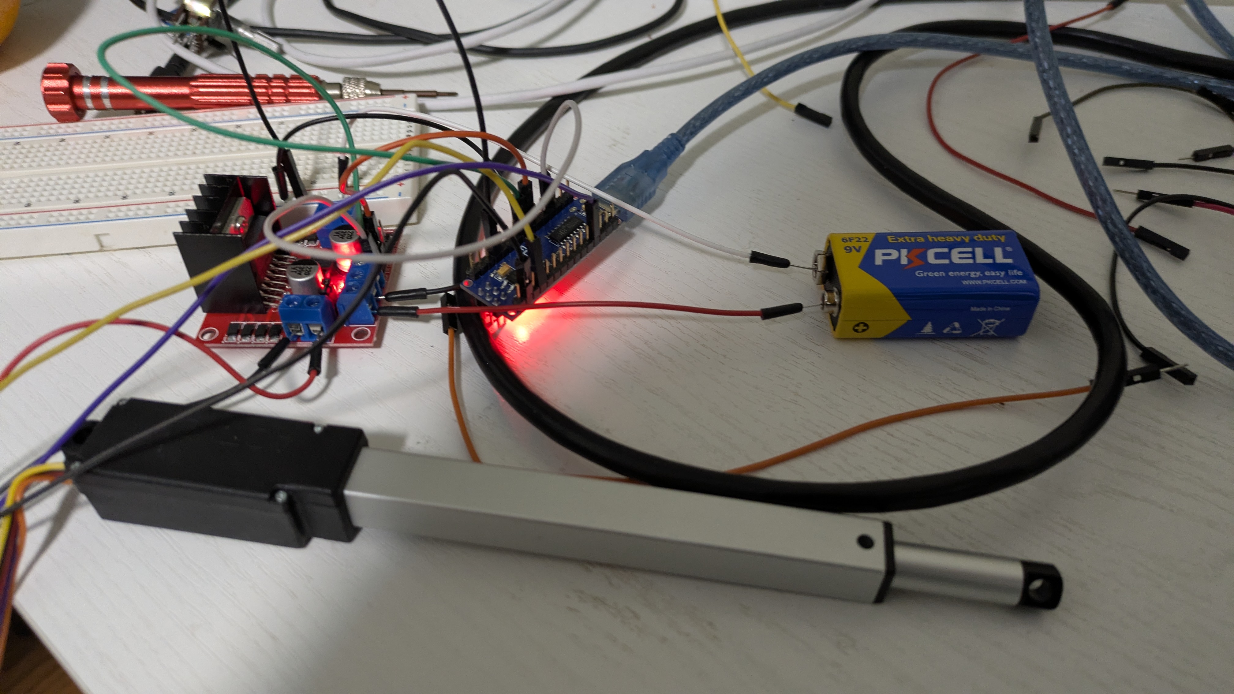 Breadboard prototype with Arduino Nano, L298N driver, and linear actuator